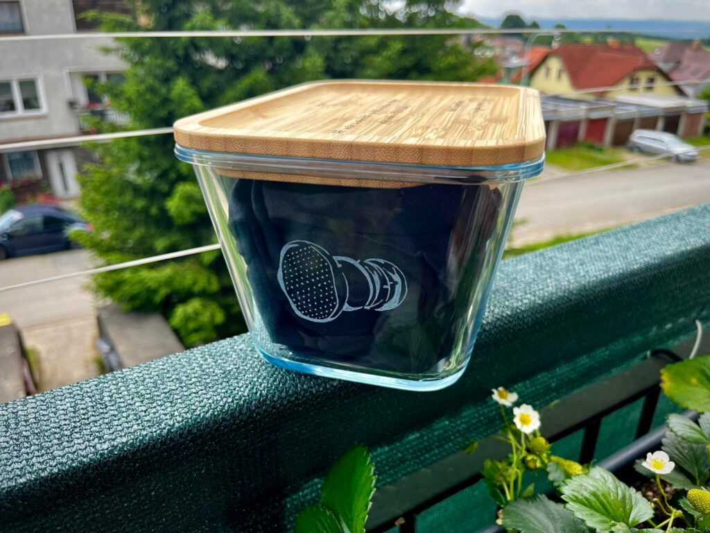 a glass container with a wooden lid